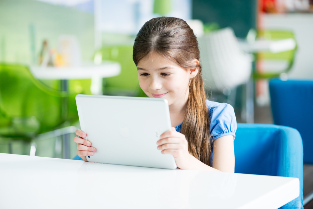 Girl using free reading apps for kids