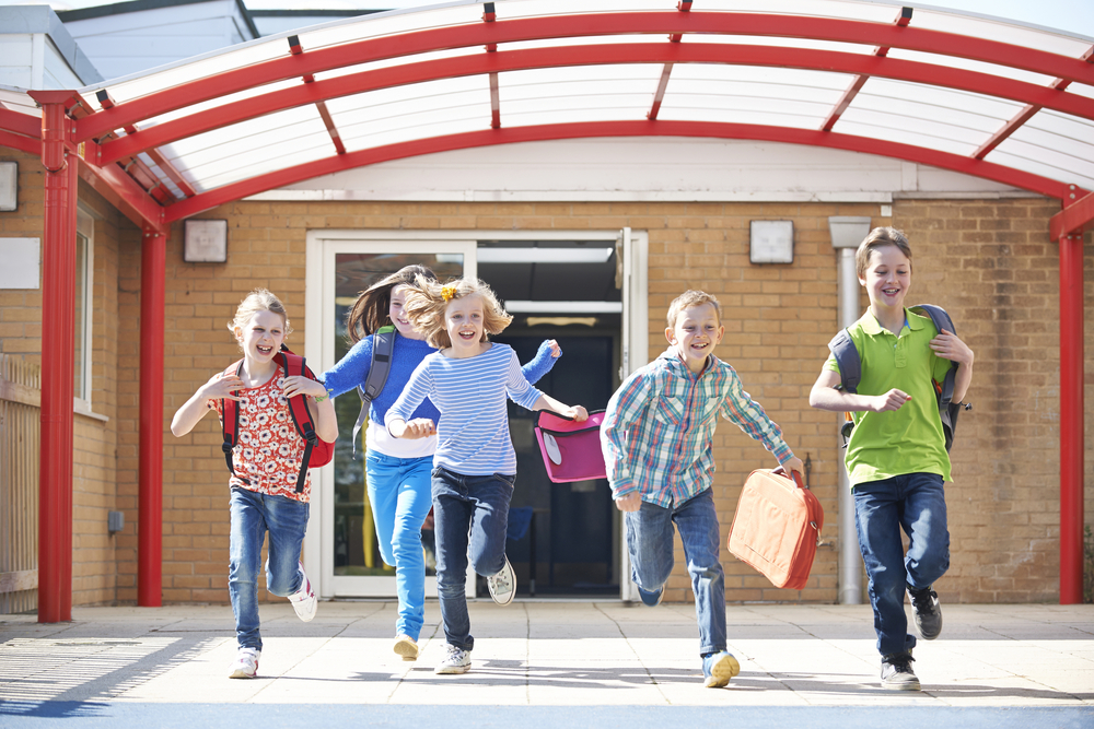 Kids running out of school happy to be free for summer vacation