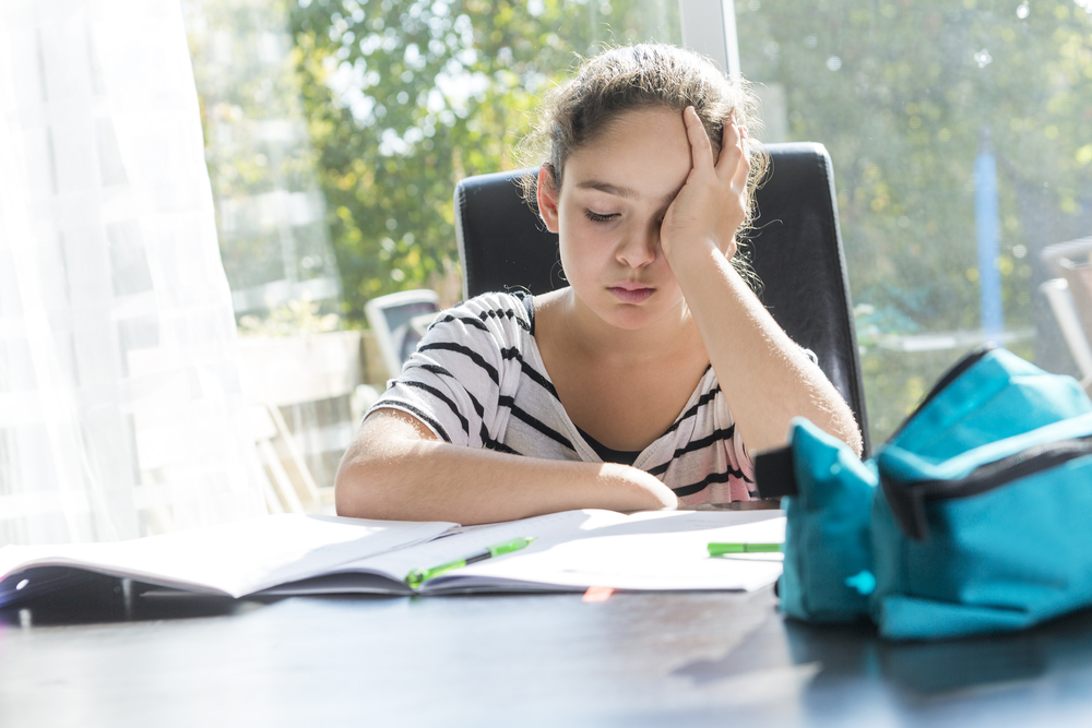 A young girl struggles with her reading homework