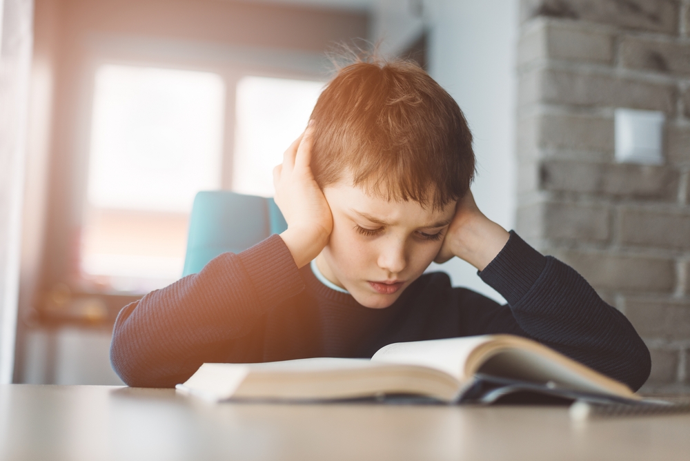 A young boy struggles to read