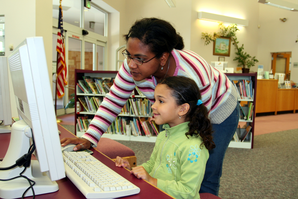 First grader reading with enjoyment and engagement, illustrating a love for books at a first-grade reading level.