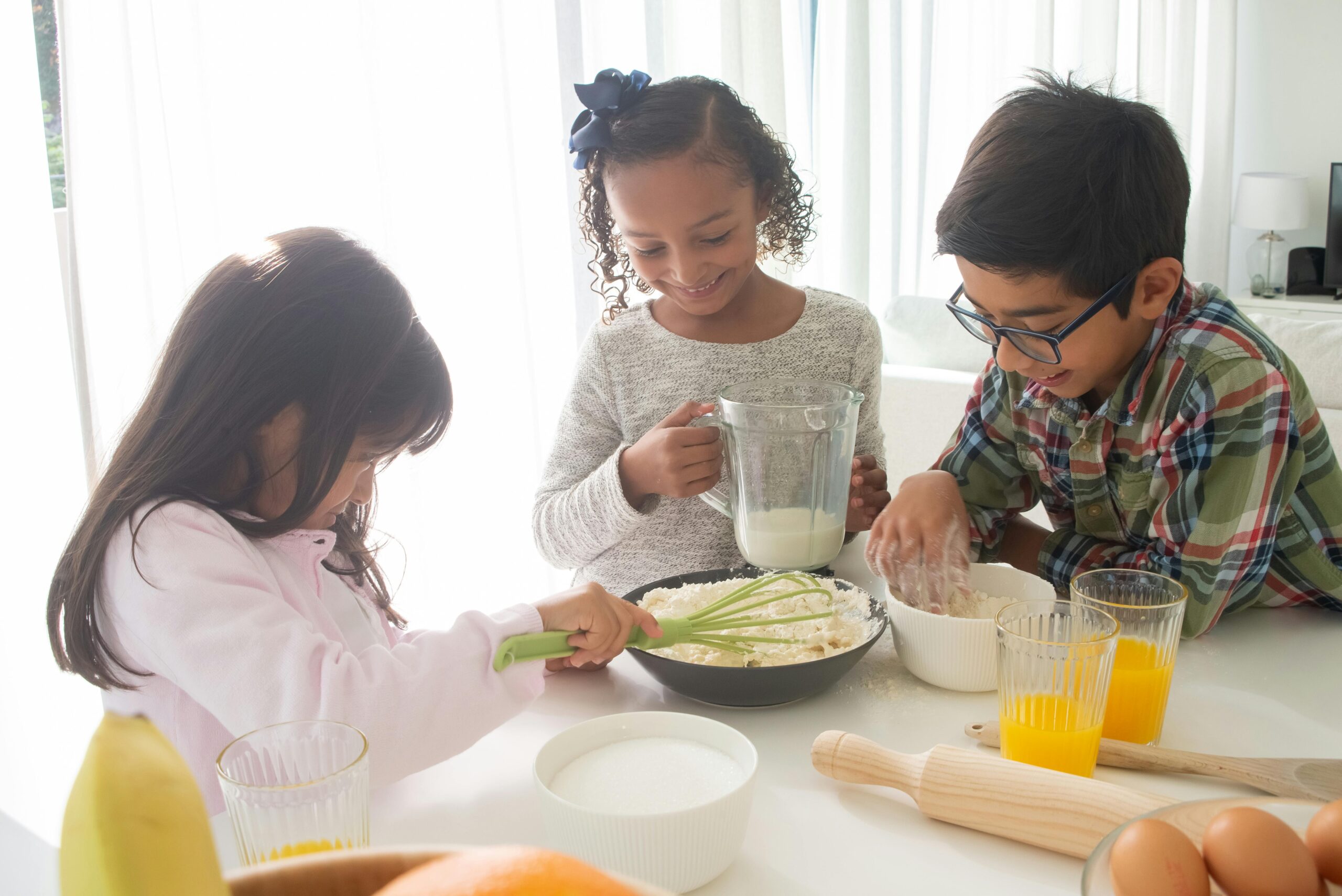 Child combines multisensory learning strategies while reading a recipe during a cooking activity.