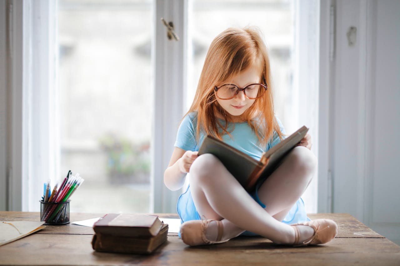 Child engaging in multisensory reading with a tactile book to enhance learning.