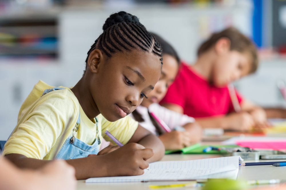 Tutor assessing a child's reading skills for an intervention program.