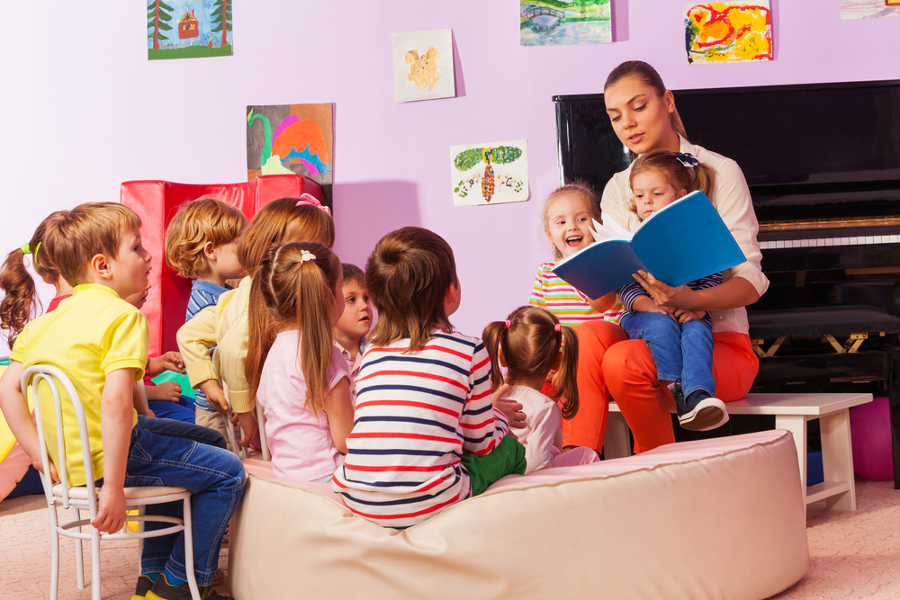 Teacher and children engaging in cognitive development learning activities in a classroom