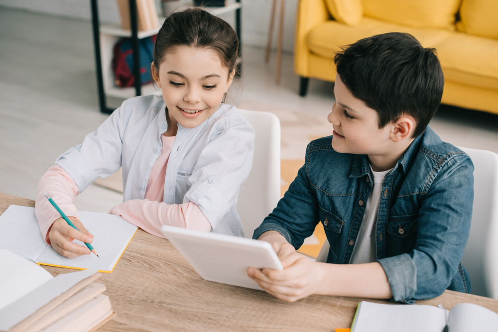 Two children working together in a classroom, exploring the science of reading