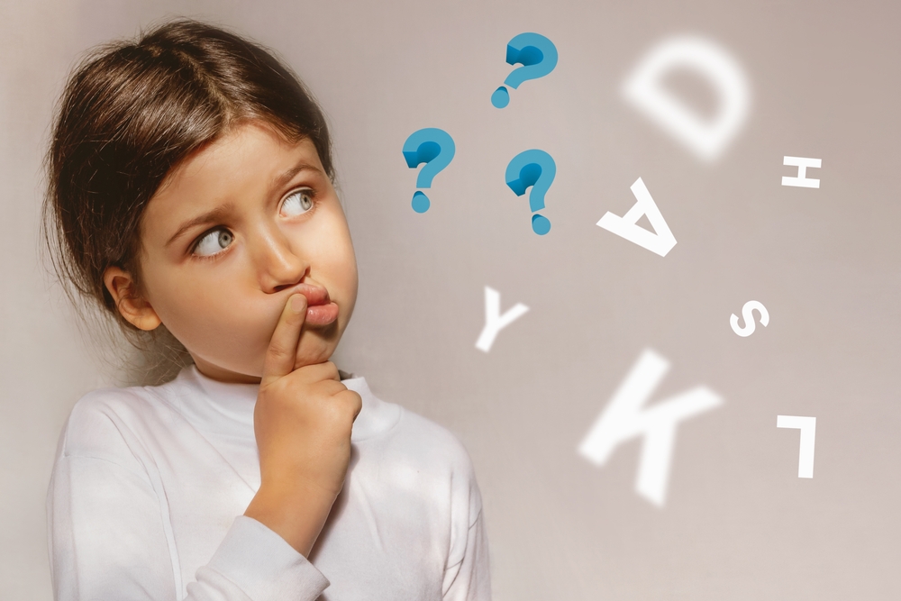 Child puzzled by letters, representing early signs of dyslexia