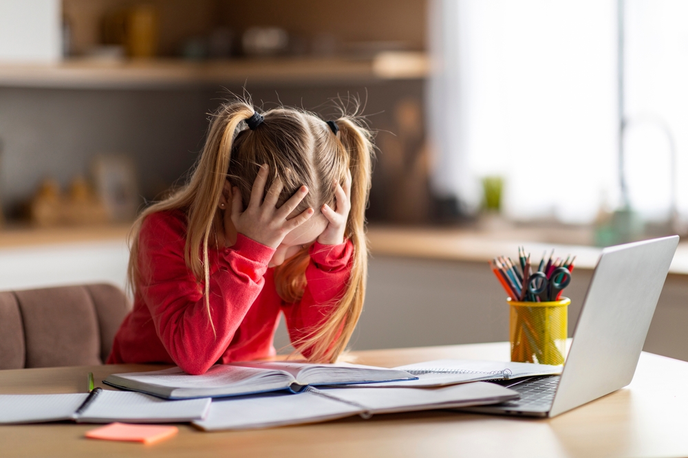Girl struggling with studies showing illiteracy in California