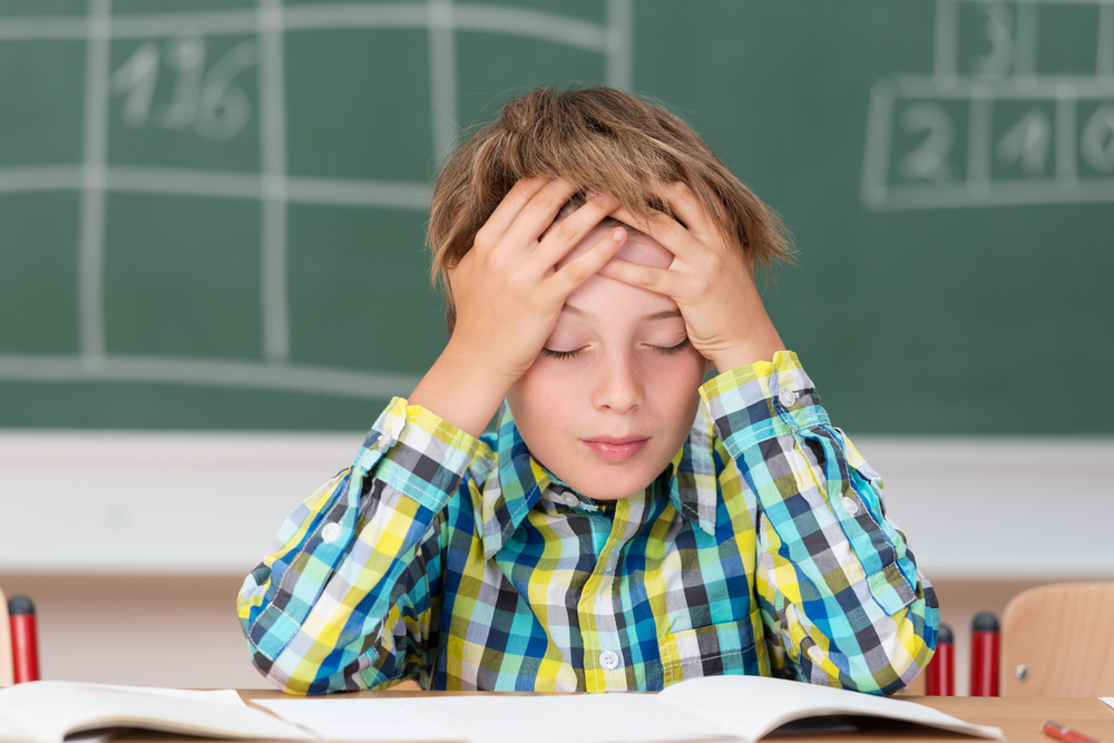 Boy facing reading fluency challenges in classroom